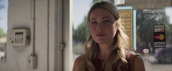 Movie still from “Born a Champion” (2021), directed by Alex Ranarivelo – A beautiful blonde woman with long hair looking out a window; Close Up shot, Low angle