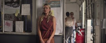 Movie still from “Born a Champion” (2021), directed by Alex Ranarivelo – A woman standing on a subway platform waiting for a train; Medium shot, Over the shoulder angle