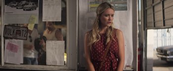 Movie still from “Born a Champion” (2021), directed by Alex Ranarivelo – A beautiful young lady wearing a red polka dot dress; Close Up shot, Over the shoulder angle