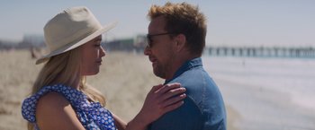 Movie still from “Born a Champion” (2021), directed by Alex Ranarivelo – A man and a woman standing next to each other on the beach; Close Up shot, Over the shoulder angle
