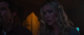 Movie still from “Born a Champion” (2021), directed by Alex Ranarivelo – A beautiful blonde haired woman in a dimly - lit room; Close Up shot, Over the shoulder angle