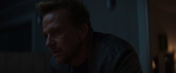 Movie still from “Born a Champion” (2021), directed by Alex Ranarivelo – A man's face in a dark room; Close Up shot, Over the shoulder angle
