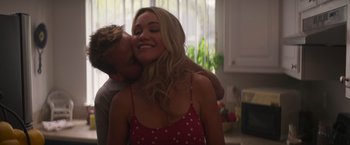 Movie still from “Born a Champion” (2021), directed by Alex Ranarivelo – A man and a woman kissing in a kitchen; Close Up shot, Low angle