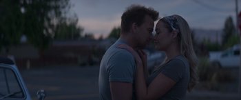 Movie still from “Born a Champion” (2021), directed by Alex Ranarivelo – A man and a woman kissing in the street; Close Up shot, Over the shoulder angle