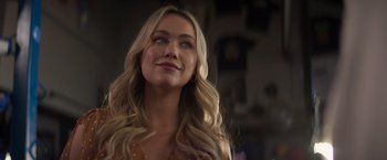 A beautiful blonde woman with long hair looking up