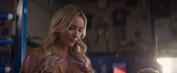 Movie still from “Born a Champion” (2021), directed by Alex Ranarivelo – A beautiful blonde woman with long hair; Close Up shot, Over the shoulder angle