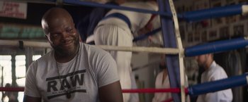 Movie still from “Born a Champion” (2021), directed by Alex Ranarivelo – A person in a boxing ring; Close Up shot, Over the shoulder angle