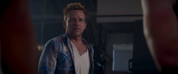 Movie still from “Born a Champion” (2021), directed by Alex Ranarivelo – A person wearing a plaid shirt; Close Up shot, Over the shoulder angle