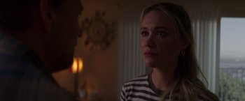 Movie still from “Born a Champion” (2021), directed by Alex Ranarivelo – A woman in a striped shirt is looking at a man; Close Up shot, Over the shoulder angle