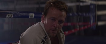 Movie still from “Born a Champion” (2021), directed by Alex Ranarivelo – A person in a boxing ring; Close Up shot, Over the shoulder angle