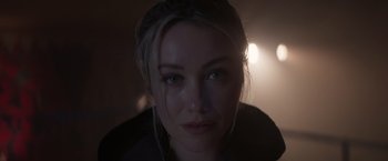 Movie still from “Born a Champion” (2021), directed by Alex Ranarivelo – A woman's face in the dark; Close Up shot, Low angle