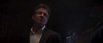 Movie still from “Born a Champion” (2021), directed by Alex Ranarivelo – A man wearing a suit and tie looking up; Close Up shot, Low angle