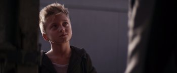 Movie still from “Born a Champion” (2021), directed by Alex Ranarivelo – A young man with spiky blond hair looking up; Close Up shot, Low angle