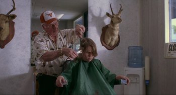Movie still from “Boyhood” (2014), directed by Richard Linklater – An older man cutting a young boy's hair in a barber shop; Medium shot, Over the shoulder angle