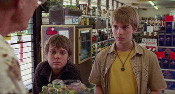 Movie still from “Boyhood” (2014), directed by Richard Linklater – Two young boys sitting at a table in a store; Close Up shot, Low angle