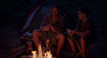 Movie still from “Boyhood” (2014), directed by Richard Linklater – A man and a woman sitting in front of a fire; Wide shot, Over the shoulder angle
