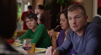 Movie still from “Boyhood” (2014), directed by Richard Linklater – A group of people sitting at a table with food; Medium shot, Over the shoulder angle