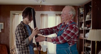 Movie still from “Boyhood” (2014), directed by Richard Linklater – An older man and a young woman holding a rifle; Medium shot, Over the shoulder angle