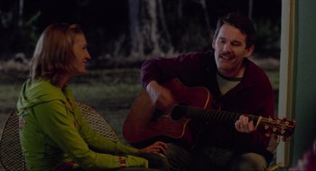 Movie still from “Boyhood” (2014), directed by Richard Linklater – A man playing an acoustic guitar for a woman; Medium shot, Over the shoulder angle