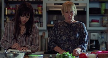 Movie still from “Boyhood” (2014), directed by Richard Linklater – Two women in a kitchen preparing a meal; Medium shot, High angle