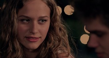 Movie still from “Boyhood” (2014), directed by Richard Linklater – A woman's face with lights in the background; Close Up shot, Over the shoulder angle