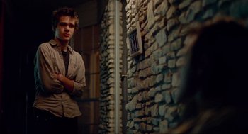 Movie still from “Boyhood” (2014), directed by Richard Linklater – A man standing in front of a brick wall; Medium shot, Over the shoulder angle