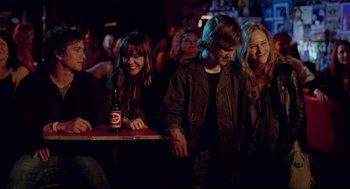 Movie still from “Boyhood” (2014), directed by Richard Linklater – A group of people sitting at a table with a beer; Medium shot, Over the shoulder angle