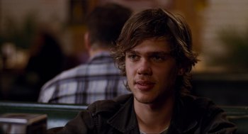 Movie still from “Boyhood” (2014), directed by Richard Linklater – A man with long brown hair sitting at a table; Close Up shot, Over the shoulder angle