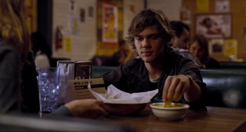 Movie still from “Boyhood” (2014), directed by Richard Linklater – A man sitting at a table with a bowl of food; Medium shot, Over the shoulder angle