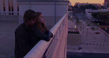 Movie still from “Boyhood” (2014), directed by Richard Linklater – A man and a woman leaning against a railing; Medium shot, Low angle