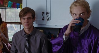Movie still from “Boyhood” (2014), directed by Richard Linklater – Two young people are posing for a picture in a kitchen; Medium shot, Over the shoulder angle