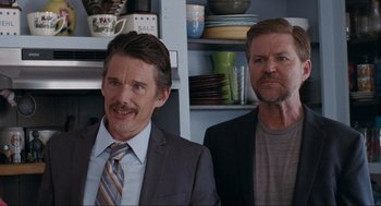 Movie still from “Boyhood” (2014), directed by Richard Linklater – A couple of men standing next to each other in a room; Medium shot, Over the shoulder angle