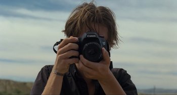 Movie still from “Boyhood” (2014), directed by Richard Linklater – A man taking a picture with a camera; Close Up shot, Low angle