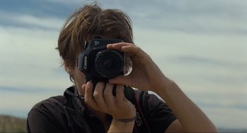 Movie still from “Boyhood” (2014), directed by Richard Linklater – A man taking a picture with a camera; Close Up shot, Low angle