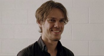 Movie still from “Boyhood” (2014), directed by Richard Linklater – A man with long hair wearing a black shirt; Close Up shot, Over the shoulder angle