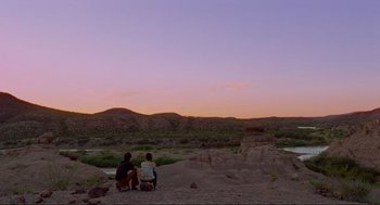 Movie still from “Boyhood” (2014), directed by Richard Linklater – Two people sitting on the ground looking at the sky; Extreme Wide shot, Low angle