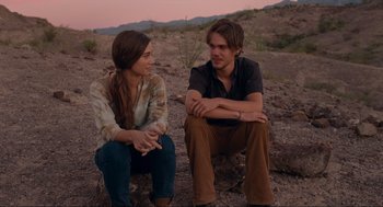 Movie still from “Boyhood” (2014), directed by Richard Linklater – A man and a woman sitting on the ground in the desert; Medium shot, Over the shoulder angle