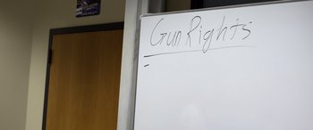 Movie still from “Boys State” (2020), directed by Amanda McBaine – A white board that says gun rights written on it; Extreme Close Up shot, High angle