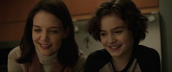Movie still from “Brahms: The Boy II” (2020), directed by William Brent Bell – Two young women sitting next to each other in a kitchen; Close Up shot, Over the shoulder angle