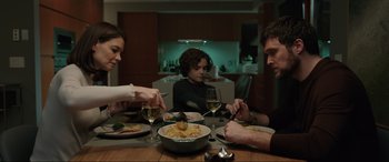 Movie still from “Brahms: The Boy II” (2020), directed by William Brent Bell – A group of people sitting at a dinner table; Medium shot, Over the shoulder angle