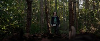 Movie still from “Brahms: The Boy II” (2020), directed by William Brent Bell – A boy standing in the middle of a forest; Wide shot, Low angle