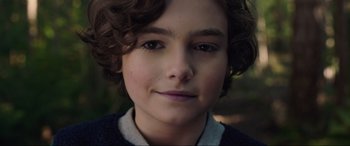 Movie still from “Brahms: The Boy II” (2020), directed by William Brent Bell – A young person's face with curly brown hair; Close Up shot, High angle