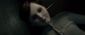 Movie still from “Brahms: The Boy II” (2020), directed by William Brent Bell – A doll with a needle in it's mouth; Close Up shot, Overhead angle