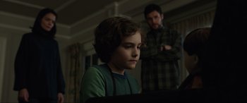 Movie still from “Brahms: The Boy II” (2020), directed by William Brent Bell – A young boy sitting in front of an older man; Medium shot, Over the shoulder angle