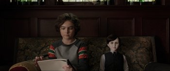 Movie still from “Brahms: The Boy II” (2020), directed by William Brent Bell – A young boy sitting next to a doll; Close Up shot, Over the shoulder angle