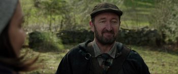 Movie still from “Brahms: The Boy II” (2020), directed by William Brent Bell – A person wearing a hat and a tie; Close Up shot, Over the shoulder angle