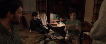 Movie still from “Brahms: The Boy II” (2020), directed by William Brent Bell – Two people sitting on a bed in a room; Medium shot, High angle