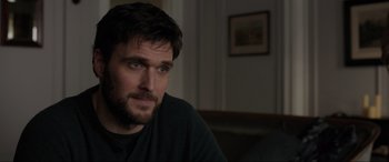 Movie still from “Brahms: The Boy II” (2020), directed by William Brent Bell – A person sitting in front of a window; Close Up shot, Over the shoulder angle