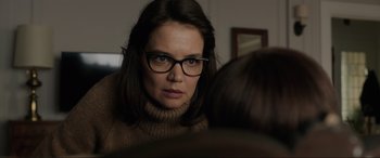 Movie still from “Brahms: The Boy II” (2020), directed by William Brent Bell – A woman wearing glasses looking at the camera; Close Up shot, Over the shoulder angle