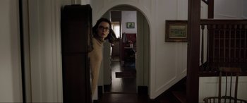 Movie still from “Brahms: The Boy II” (2020), directed by William Brent Bell – A woman leaning against a wall in a room; Medium shot, Low angle